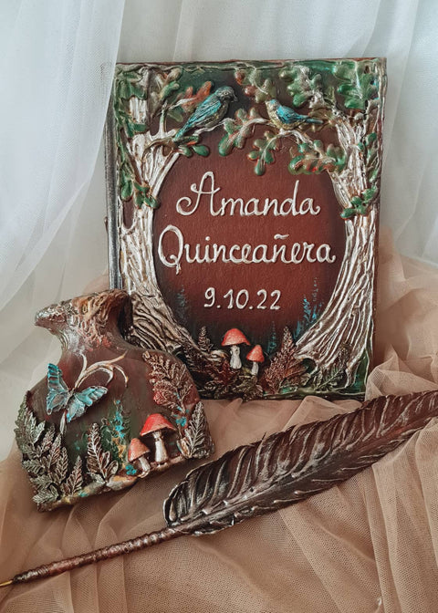 A decorative personalized keepsake box with a carved forest design and the text 'Amanda Quinceañera 9.10.