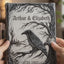 Handcrafted 3D gothic raven wedding guest book featuring sculpted tree branches, carved heart with initials, and personalized names and date