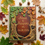 Handheld custom woodland wedding guest book featuring sculpted fall leaves and rustic tree trunk detailing.