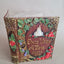 An ornate decorative book-shaped keepsake box with embossed floral details, gold lettering reading 'Once Upon a Time June 6 2026,' and a small castle motif on the front, photographed against a plain light gray background.