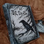 A gothic-style hardcover journal titled 'Til Death' featuring a black raven perched on tree branches over a dark landscape, resting on a brown textured fabric background.