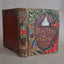 An ornate decorative keepsake box styled like a vintage book, featuring embossed gold detailing, red roses, green leaves, and a white castle illustration on a dark brown cover. The front reads 'Once Upon A Time June 6 2026' with an '8+12' emblem.
